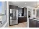 Modern kitchen featuring stainless steel refrigerator, dark wood cabinets, and white countertops at 400 4Th S Ave # 704, St Petersburg, FL 33701