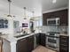 Modern kitchen with stainless steel appliances, marble counters, and stylish pendant lighting at 400 4Th S Ave # 704, St Petersburg, FL 33701