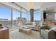 Bright living room with floor-to-ceiling windows offering cityscape views and stylish furnishings at 400 4Th S Ave # 704, St Petersburg, FL 33701