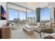 Comfortable living room with large windows offering city views, stylish decor and modern furniture at 400 4Th S Ave # 704, St Petersburg, FL 33701
