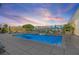 Rooftop pool with lounge chairs, umbrellas, and views of the city skyline at sunset, perfect for relaxation and entertainment at 400 4Th S Ave # 704, St Petersburg, FL 33701
