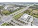 Aerial view of a highway intersection and businesses, showing the surrounding area and accessibility at 4016 Cadence Loop, Land O Lakes, FL 34638