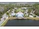 Aerial view showcasing a lakeside clubhouse and sprawling recreational area with a swimming pool at 4016 Cadence Loop, Land O Lakes, FL 34638