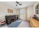 Cozy bedroom with ceiling fan, window with curtains, and ample natural light at 4016 Cadence Loop, Land O Lakes, FL 34638