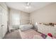 Charming bedroom with a white canopy bed, pink accents, and a bright, airy feel at 4016 Cadence Loop, Land O Lakes, FL 34638