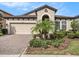 Beautiful single-Gathering home with manicured front yard, garage, and arched entryway at 4016 Cadence Loop, Land O Lakes, FL 34638