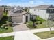 Single Gathering home featuring a well-maintained lawn, arched entryway, two car garage and solar panels at 4016 Cadence Loop, Land O Lakes, FL 34638