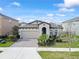 Charming single-Gathering home boasts a manicured lawn, arched entryway, and a two-car garage at 4016 Cadence Loop, Land O Lakes, FL 34638