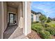 Inviting front porch with brick pavers, stylish front door, and manicured landscaping at 4016 Cadence Loop, Land O Lakes, FL 34638