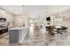 Open-concept living room featuring a seamless flow into the dining and kitchen areas at 4016 Cadence Loop, Land O Lakes, FL 34638