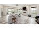Modern living room with a fireplace, TV, tile floors, and a comfortable sectional sofa at 4016 Cadence Loop, Land O Lakes, FL 34638