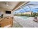 Inviting screened patio featuring an outdoor dining area overlooking a refreshing swimming pool and backyard at 4016 Cadence Loop, Land O Lakes, FL 34638