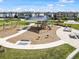 A modern playground area with swings, slides, and seating areas for families and children at 4016 Cadence Loop, Land O Lakes, FL 34638