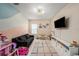 Colorful playroom with a comfortable sofa, TV, and lots of toy storage at 4016 Cadence Loop, Land O Lakes, FL 34638