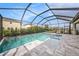 Sparkling screened-in pool with a built-in spa and ample patio space for outdoor relaxation and entertainment at 4016 Cadence Loop, Land O Lakes, FL 34638