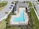 Aerial view of a large community pool area with plenty of seating and a nearby parking area at 4016 Cadence Loop, Land O Lakes, FL 34638
