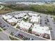 Aerial view of a shopping center with various stores, ample parking, and pedestrian-friendly walkways at 4016 Cadence Loop, Land O Lakes, FL 34638
