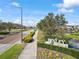 Scenic view of the Bexley community entrance, featuring lush greenery, landscaping, and clear blue skies at 4016 Cadence Loop, Land O Lakes, FL 34638