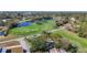 Aerial view of a home on a golf course near a pond with a water feature, showcasing a serene setting at 4100 Narvarez S Way, St Petersburg, FL 33712
