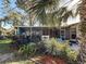 Inviting screened-in porch with decorative plants and tiled patio, perfect for outdoor living and enjoying the garden at 4100 Narvarez S Way, St Petersburg, FL 33712