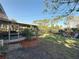 Back yard with a screened-in porch area, green grass, and a sitting area at 4100 Narvarez S Way, St Petersburg, FL 33712