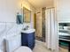 Bathroom features stylish mosaic-tiled shower, modern fixtures, and ample storage in white cabinets at 4100 Narvarez S Way, St Petersburg, FL 33712