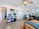 Bright bedroom featuring a ceiling fan, closet space, and decorative wall art and plants, and modern furniture at 4100 Narvarez S Way, St Petersburg, FL 33712