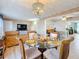 Elegant dining room featuring a chandelier and connecting to the living area at 4100 Narvarez S Way, St Petersburg, FL 33712