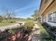 Beautifully landscaped front yard featuring a stone walkway and view of the green lawns and golf course at 4100 Narvarez S Way, St Petersburg, FL 33712