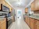 Kitchen with stainless steel appliances, granite countertops, and light wood cabinets at 4100 Narvarez S Way, St Petersburg, FL 33712