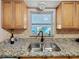 Kitchen sink featuring granite countertops and a view to the outdoor lanai at 4100 Narvarez S Way, St Petersburg, FL 33712