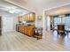 Spacious kitchen with wood cabinets, stone countertops, and an open layout to the living and dining areas at 4100 Narvarez S Way, St Petersburg, FL 33712