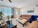 Comfortable living room with a large window, neutral paint, wood floors, and a plush sectional at 4100 Narvarez S Way, St Petersburg, FL 33712