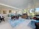 Spacious screened patio with a dining table, seating area, and lush green backyard view at 4100 Narvarez S Way, St Petersburg, FL 33712