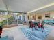 Inviting screened patio with dining set, comfortable seating, and views of the serene backyard at 4100 Narvarez S Way, St Petersburg, FL 33712