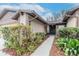 Inviting front entrance with lush bushes, leafy ground cover, and a clean concrete walkway to the front door at 415 Bloomingfield Dr, Brandon, FL 33511