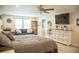 Spacious main bedroom featuring a sitting area, ensuite, and ceiling fan at 4237 Balcony Breeze Dr, Land O Lakes, FL 34638