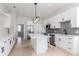 Modern kitchen with white cabinets, stainless steel appliances, and central island at 4411 Miley Rd, Plant City, FL 33565