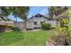 The backyard has a grassy area, shrubbery and the home's exterior at 4804 N 10Th St, Tampa, FL 33603
