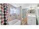This bathroom features a shower-tub combo with tiled walls, a vanity with storage, and modern fixtures at 4804 N 10Th St, Tampa, FL 33603