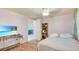 Bedroom features wood floors, a ceiling fan and a television at 4804 N 10Th St, Tampa, FL 33603