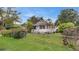 Inviting home boasts lush green lawn, mature trees, and charming curb appeal at 4804 N 10Th St, Tampa, FL 33603