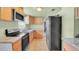 The kitchen features granite countertops, stainless steel appliances, and wood cabinets at 4804 N 10Th St, Tampa, FL 33603