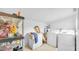 This laundry room features modern appliances, storage shelving, and ample space at 4804 N 10Th St, Tampa, FL 33603