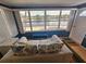 Cozy waterfront living room with a sofa, large windows, and great views of the water and skyline beyond at 4851 W Gandy Blvd # 14C, Tampa, FL 33611