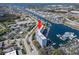 Stunning aerial view of waterfront condo building with docks and boat slips on a sunny day at 4939 Floramar Ter # 208, New Port Richey, FL 34652