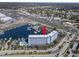 Aerial view of the condo building near the marina, waterway, and retail areas at 4939 Floramar Ter # 208, New Port Richey, FL 34652