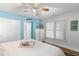Relaxing bedroom with white dresser, wooden floors, and a large window at 4939 Floramar Ter # 208, New Port Richey, FL 34652