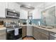 Well-equipped kitchen featuring stainless steel appliances and a tiled backsplash and plenty of counter space at 4939 Floramar Ter # 208, New Port Richey, FL 34652