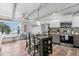 Open kitchen and dining area with stainless steel appliances, pendant lighting, and scenic views at 4939 Floramar Ter # 208, New Port Richey, FL 34652
